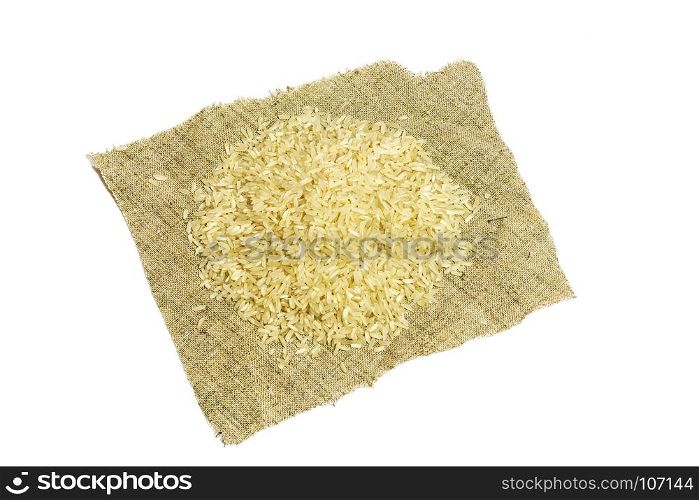On a white background there is a napkin with a handful of rice croup