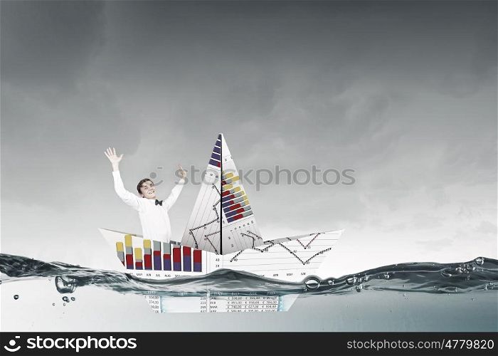 On board of paper ship. Businessman floating in boat made of paper