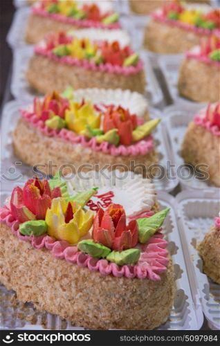 On cakes production. cakes production on factory: closeup photo of prepared cakes
