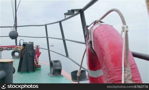 On deck of commercial fishing boat in the misty sea