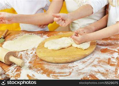 on kitchen table preparing dough