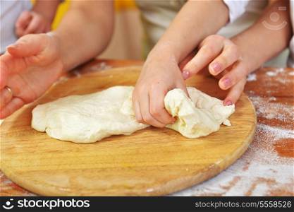 on kitchen table preparing dough