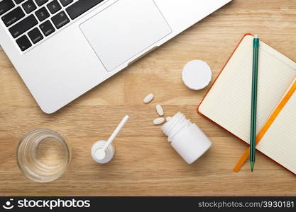 On-line treatment antivirus concept with bottles of medicine pills on the table. On-line treatment antivirus concept with bottles of medicine pills on the wooden table