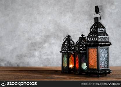 On table top image of decorations Ramadan Kareem holiday background.Close up Arabic lantern metal on brown wooden.Lighing sign for Muslim or Isiam religion.copy space for creative design text.