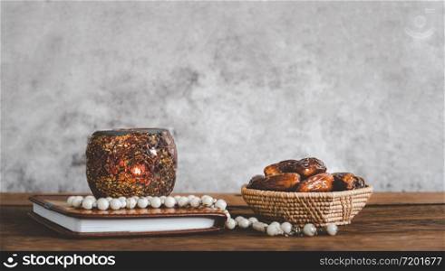 On table top image of decorations Ramadan Kareem holiday background.Close up Arabic lantern metal date and milk on brown wooden.Halal meal set for fasting is obligatory for Muslim.copy space design.