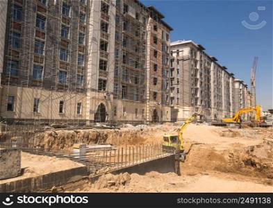 on the construction site, excavator and dump truck. construction machinery and buildings