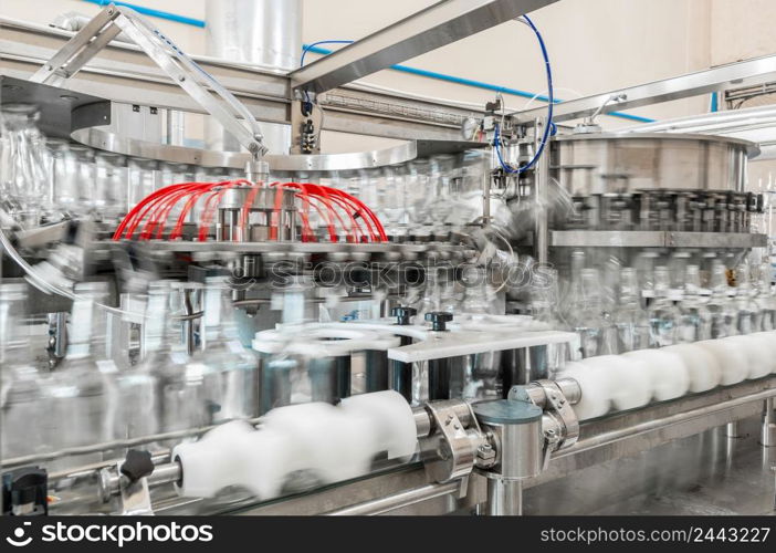 on the conveyor belt glass bottles. factory shop for the production of glass bottles and beverage. beverage manufacturing plant