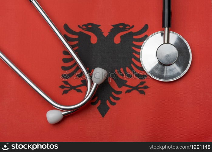 On the flag of Albania is a stethoscope. The concept of medicine.. On the flag of Albania is a stethoscope.