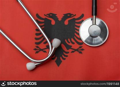 On the flag of Albania is a stethoscope. The concept of medicine.. On the flag of Albania is a stethoscope.