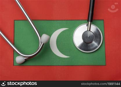 On the flag of the Maldives is a stethoscope. The concept of medicine.. On the flag of the Maldives is a stethoscope.