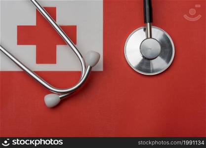 On the flag of Tonga is a stethoscope. The concept of medicine.. On the flag of Tonga is a stethoscope.