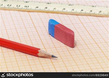On the millimeter paper is a simple pencil close-up with an eraser and ruler