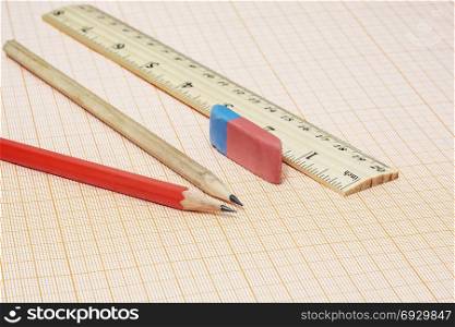 On the millimeter paper there are two simple pencils with an eraser and a ruler