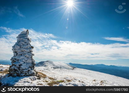 On the pot of the mountain. Winter landscape with white snow and sun rays.