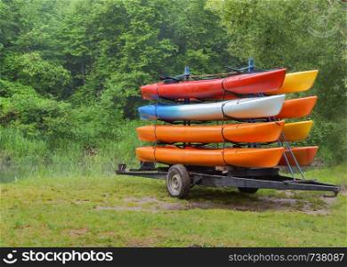 on the trailer with eight canoes, kayaks by car delivered to the river. kayaks by car delivered to the river, on the trailer with eight canoes