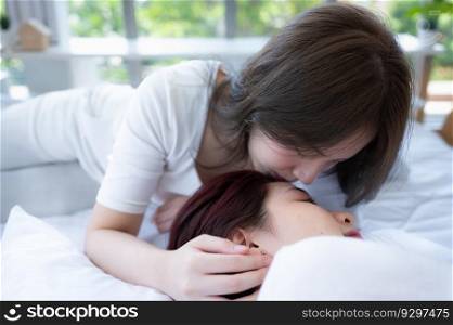 On the white bed, an LGBT couples happily touch and caress each other