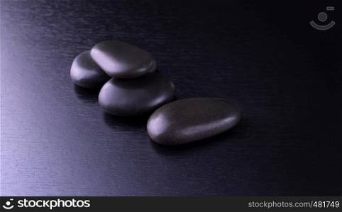 On top black stones for Thai spa on black wooden background