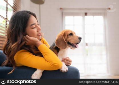 On weekends, a beagle and her owner sit in their living room,