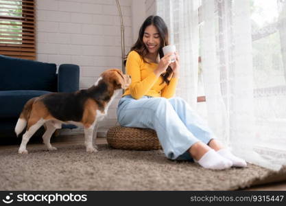 On weekends, a beagle and her owner sit in their living room, sipping coffee and gazing out the window.