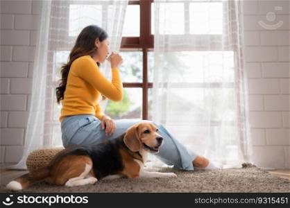 On weekends, a beagle and her owner sit in their living room, sipping coffee and gazing out the window.