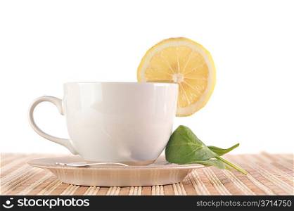 On wooden napkin full cup of tea with lemon