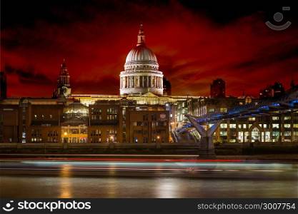 ondoners walking through Millennium Bridge with St.Paul&rsquo;s Cathedral at the background after sunset - London, UK