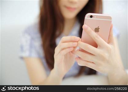 one Asian woman with smart phone