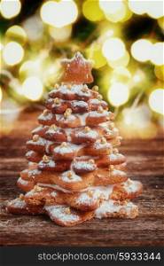 one baked gingerbread tree with christmas lights in background, retro toned