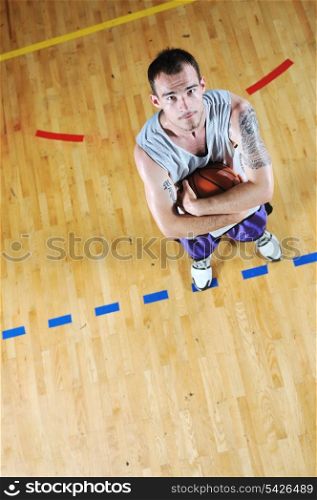 one basket ball game player standing in sport gym with ball