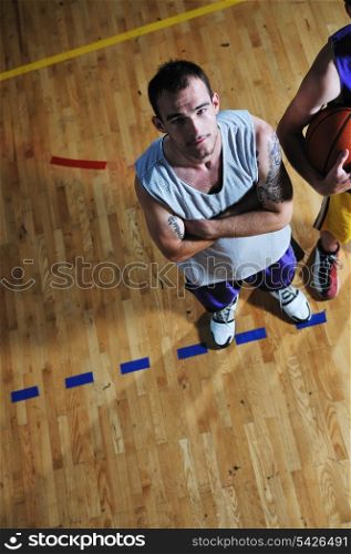 one basket ball game player standing in sport gym with ball