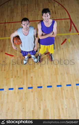 one basket ball game player standing in sport gym with ball