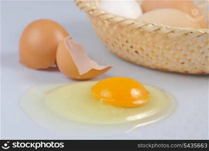 One beige cracked egg with basket on kitchen. Preparation.