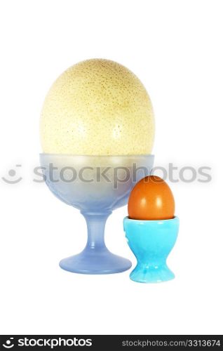 One big and one small egg on the pedestal isolated on the white