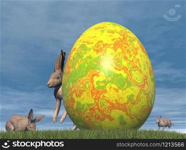 One big easter egg and cute brown hares in the grass by day. Easter egg - 3D render