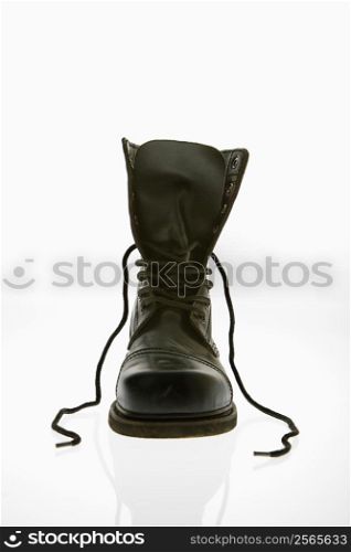 One black leather high top boots with untied laces.