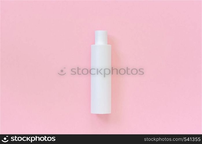 One blank white plastic cosmetic bottle for shampoo, lotion, cream or other cosmetic product on pink background. Template or Mock up for your design. Copy space Top view.. One blank white plastic cosmetic bottle for shampoo, lotion, cream or other cosmetic product on pink background. Template or Mock up for your design. Copy space Top view