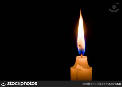 One candle is burning bright on a dark background.