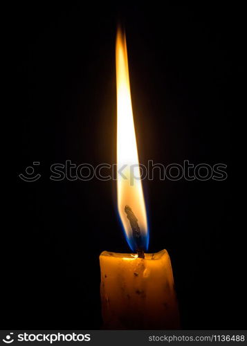 One Candle light on black background, Candlelight shines light into the destination.