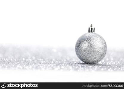 One chritmas ball on glitters isolated on white background