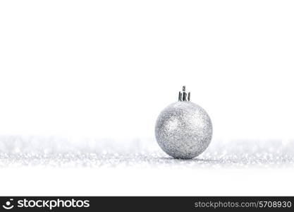 One chritmas ball on glitters isolated on white background