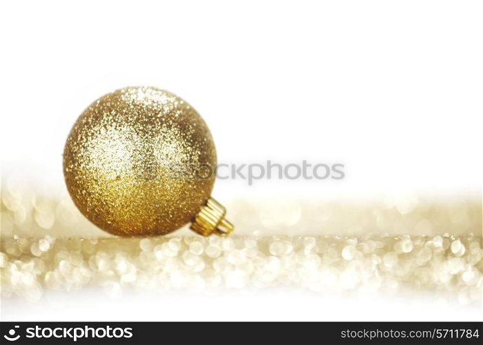 One chritmas ball on glitters isolated on white background