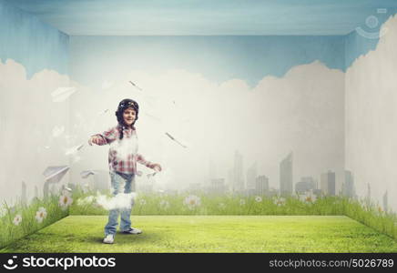 One day I&rsquo;ll become a pilot. Little cute boy in pilot helmet and paper airplanes flying around