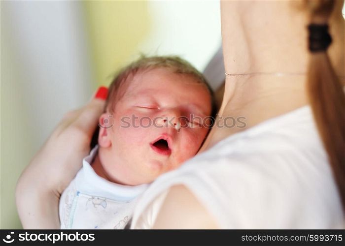 One day old newborn baby with his mother