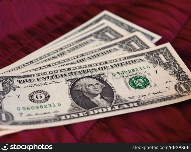 One Dollar notes, United States over red velvet background. One Dollar banknotes money (USD), currency of United States over crimson red velvet background