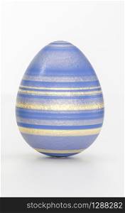 One Easter eggs art concept with striped black golden decoration in close-up against grey background with copy space