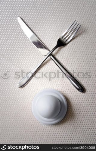 One egg with crossed knife and fork