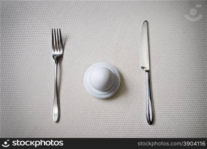One egg with knife and fork