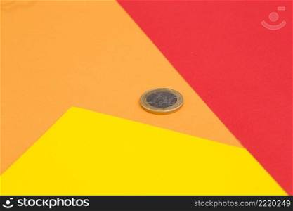 one euro coin red yellow orange colored background