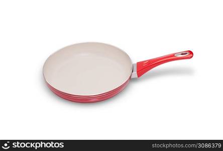 one frying pan of red color on a white background closeup. frying pan on a white background
