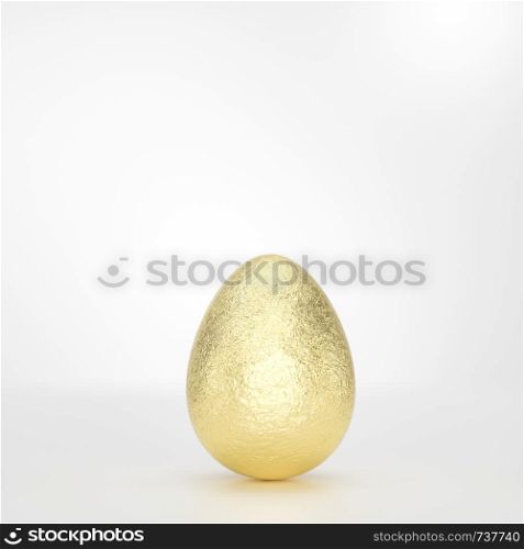 One golden Easter egg on grey background in close-up, balanced vertically on its blunt end